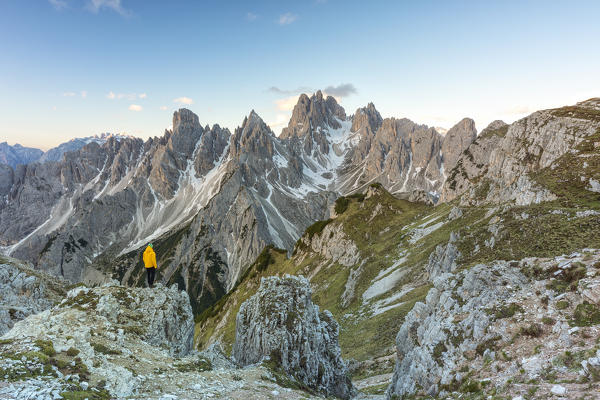 a person enjoys the sunrise while admiring the Cadini of Misurina in summer time, Dolomiti, municipality of Auronzo di Cadore, Belluno province, Veneto district, Italy, Europe