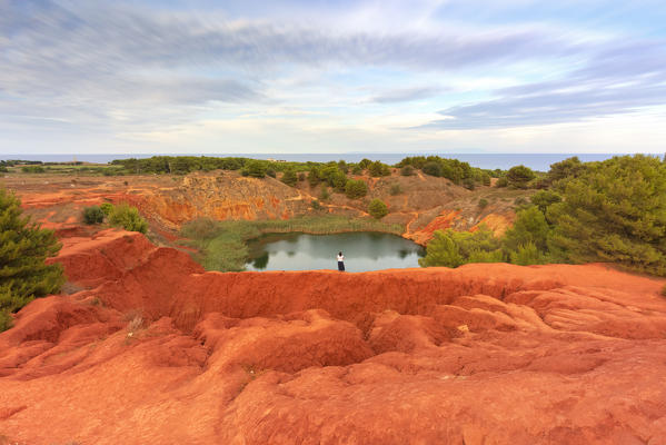 one person enjoy the colors of the bauxite quarry, located along the Adriatic coast near Otranto, municipality of Otranto, Lecce province, Apulia district, Italy, Europe