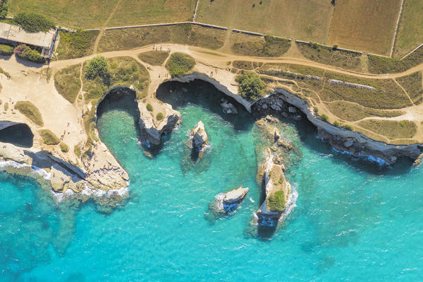 aerial view of the Faraglioni di Sant'Andrea in summer time, located along the Adriatic coast, municipality of Meledugno, Lecce province, Apulia district, Italy, Europe