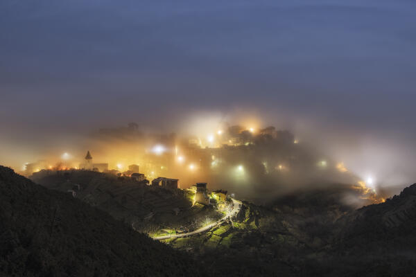 the Caligo envelops the Ligurian coast, in the village of Corniglia, during a spring night, municipality of Vernazza, Cinque Terre  National Park, UNESCO World Heritage Site, La Spezia province, Liguria district, Italy, Europe