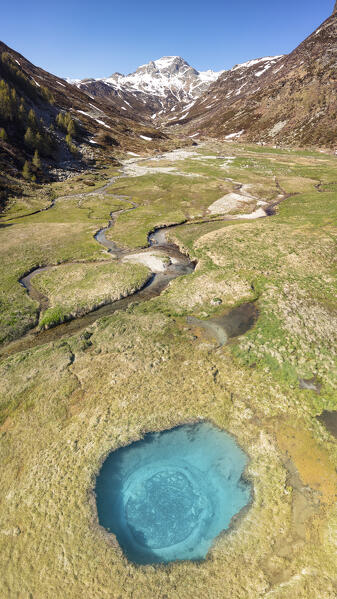 aerial view taken by drone of blue hole near to Madesimo with in background the  Pizzo Spadolazzo mountain, Orobie Alps, Valtellina, municipality of Madesimo, Sondrio province, Lombardy district, Italy, Europe