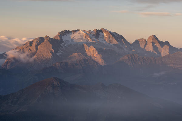 the first light envelope the peak of Marmolada mountain during a summer sunrise, Dolomiti, Veneto district, Italy, Europe