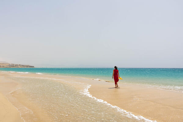 a tourist admires the view near the Playa de Sotavento during a sunny summer day, Fuerteventura, Canary Island, Spain, Europe