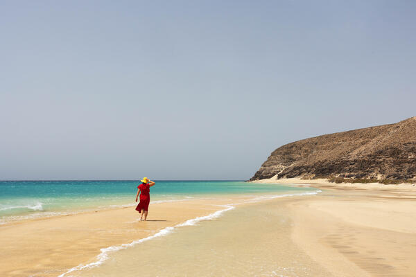 a tourist admires the view near the Playa de Sotavento during a sunny summer day, Fuerteventura, Canary Island, Spain, Europe
