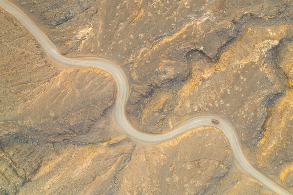 aerial vertical view taken by drone of one car driving along the gravel road to Playa de Cofete, Natural Park de Jandia, Fuerteventura, Canary Island, Spain, Europe