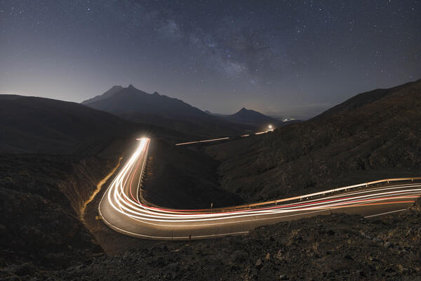 a magical night at Mirador astronomico de Sicasumbre during a summer night with milky way and car trails, Sicasumbre, Fuerteventura, Canary Island, Spain, Europe