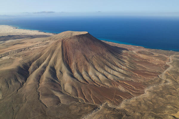 aerial view taken by drone of the Montaña Roja volcano, during a summer day, Natural Park of Corralejo, Fuerteventura, Canary Island, Spain, Europe
