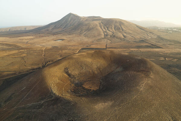 aerial view taken by drone of the Montaña Negra Volcano, Natural Park of Corralejo, shooted during a summer day, Fuerteventura, Canary Island, Spain, Europe