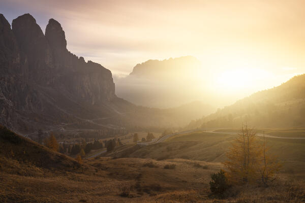 an amazing warm light envelope the landscape at Gardena pass, during an autumn sunset, Gardena valley, Bolzano province, Trentino Alto Adige, Dolomiti, Italy, Europe
