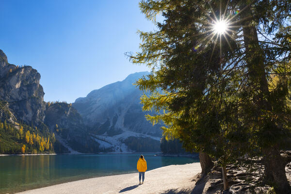 one girl enjoy the beautiful view at Braies lake during an autumn sunny day, Bolzano province, Trentino Alto Adige, Dolomiti, Italy, Europe