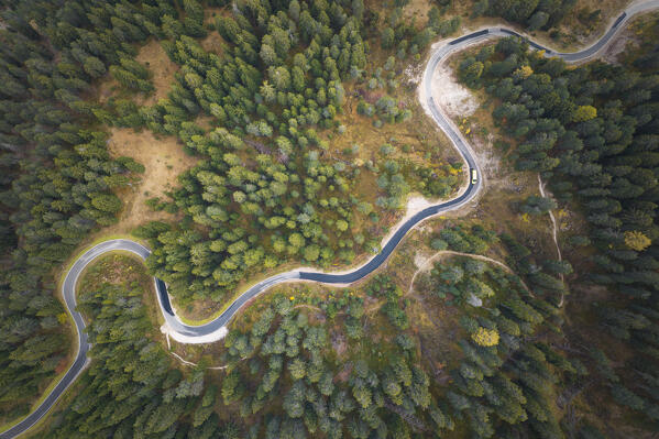 one car driving along the majestic Dolomites roads during an autumn day, northern Italy, Europe