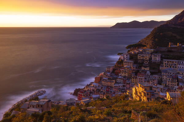 a long exposure to capture the warm light of sunset at Riomaggiore, Cinque Terre, Liguria, Italy, Europe