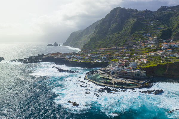 Aerial view of the city center of Porto Maniz during a spring day of rough seas, Porto Moniz, Madeira, Portugal, Europe
