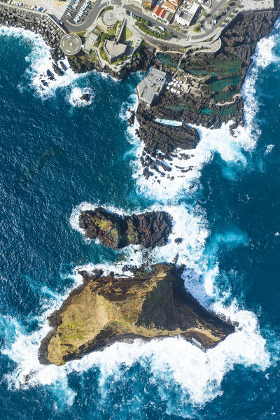 Vertical aerial view of the natural pools located in the city center of Porto Maniz during a spring day of rough seas, Porto Moniz, Madeira, Portugal, Europe