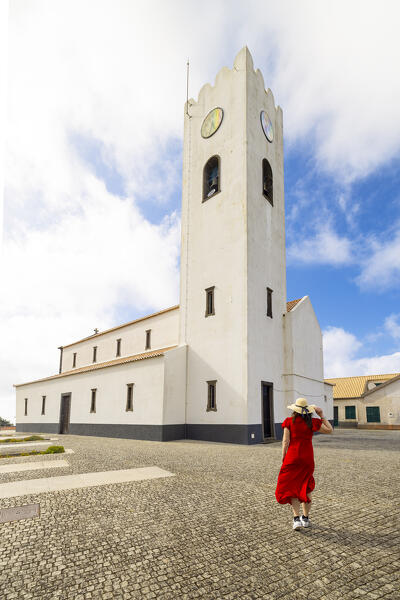 A girl admire the Church of Santa Maria Madalena during a sunny spring day, Madeira, Portugal, Europe