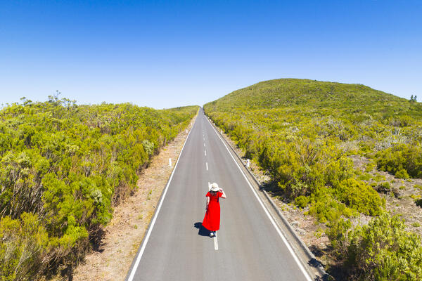 A girl enjoys the beautiful sunny day along the mountain road near to Fanal Forest , Porto Moniz, Madeira, Portugal, Europe