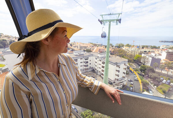 a girl enjoys the beautiful panorama seen from Funchal cable car, during a spring sunny day, Funchal, Madeira, Portugal, Europe