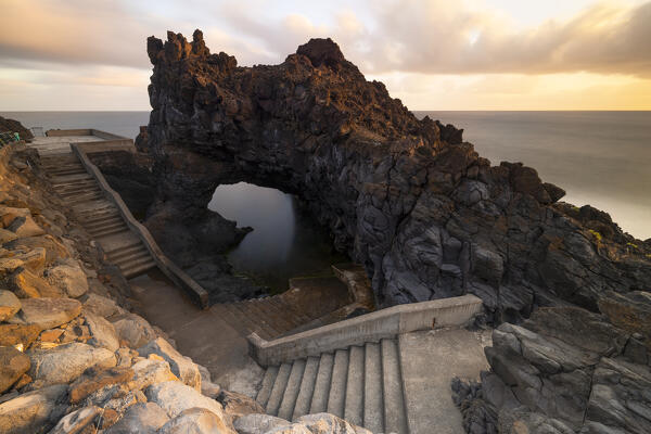 a long exposure to take the warm light of the sunrise at the natural pools of Seixal, Madeira, Portugal, Europe