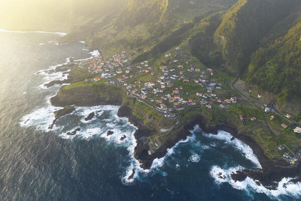 Aerial view taken from a drone of the coast of Seixal during a spring sunrise with warm enveloping light, Madeira, Portugal, Europe