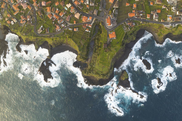 Aerial view taken from a drone of the coast of Seixal during a spring sunrise with warm enveloping light, Madeira, Portugal, Europe