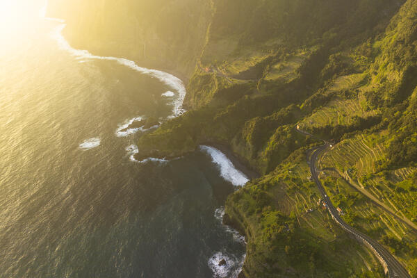 Aerial view taken from a drone of the coast of Seixal during a spring sunrise with warm enveloping light, Madeira, Portugal, Europe