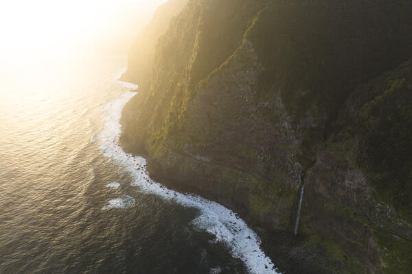 Aerial view taken from a drone of the coast of Seixal during a spring sunrise with warm enveloping light, Madeira, Portugal, Europe