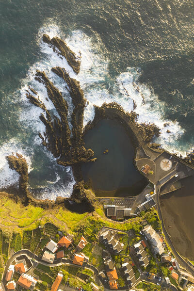 Aerial view taken from a drone of the coast of Seixal during a spring sunrise with warm enveloping light, Madeira, Portugal, Europe