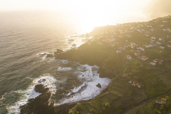 Aerial view taken from a drone of the coast of Seixal during a spring sunrise with warm enveloping light, Madeira, Portugal, Europe