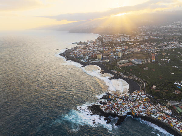 aerial view taken by drone of the coastal city of Puerto de la Cruz, during a beautiful sunrise, Tenerife, Canary Island, Spain, Europe