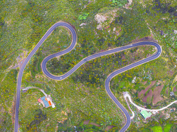 aerial view taken from the drone of cars driving along one of the winding mountain roads during a sunny day, Tenerife, Canary Island, Spain, Europe