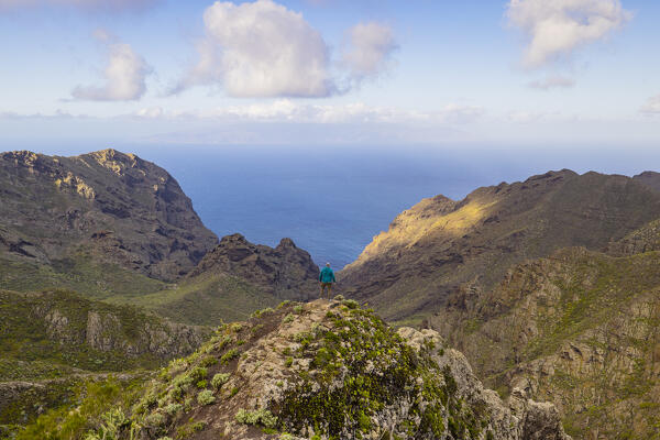 a man enjoy the beautiful view from Mirador Altos de Baracan with in background the ocean, Tenerife, Canary Island, Spain, Europe