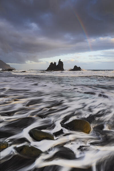 a beautiful sunrise whit a rainbow captured by the photographer along Benijo beach , during a spring day, Tenerife, Canary Island, Spain, Europe