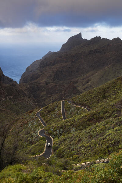A car drives along the iconic road to the village of Masca during a sunny spring morning, Tenerife, Canary Islands, Spain, Europe