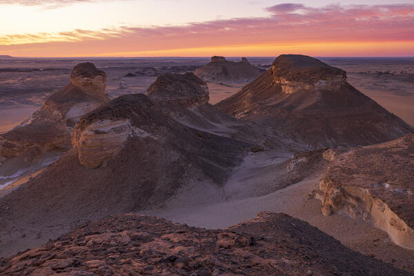 an incredible light preceding the blue hour illuminates the spectacular rock formations of the White Desert landscape, during a beautiful winter day