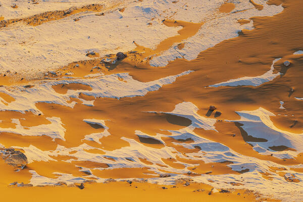 The first rays of the sun illuminate the spectacular rock formations of the incredible landscape of the White Desert, during a beautiful winter day, Egypt, Africa