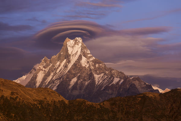 Lenticular clouds at sunset above Machapuchare, Himalayas, Nepal