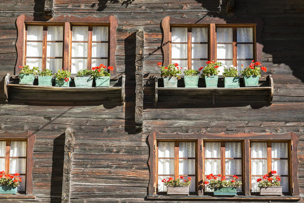 Wood windows of traditional house in the walser village of Grovella, Val Formazza, Verbano Cusio Ossola province, Piedmont, Italy