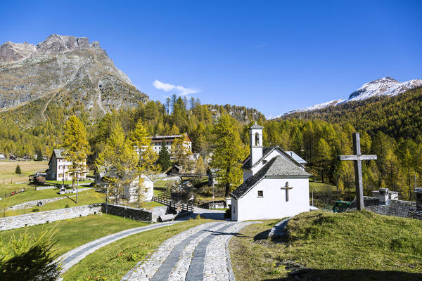 Church and houses in the green landscape of Alpe Devero, Val Formazza, Verbano Cusio Ossola province, Piedmont, Italy