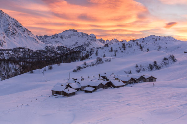 Sunset over the alpine village of Grevasalvas covered with snow, Engadine, canton of Graubunden, Switzerland