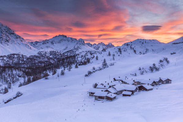 Sunset on the alpine village of Grevasalvas after a snowfall, Engadine, canton of Graubunden, Switzerland
