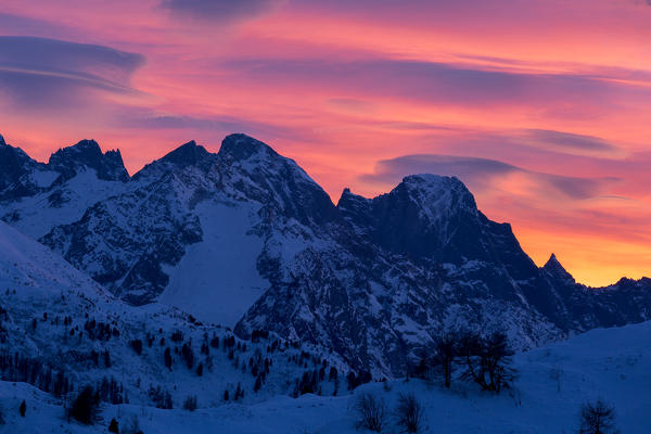 Pink sky at sunset over the snowcapped Piz Cengalo and Piz Badile, Bregaglia Valley, Engadine, canton of Graubunden, Switzerland