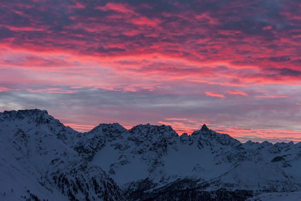 Pink sunrise on snowy peaks of Engadine view from Bernina Pass, canton of Graubunden, Switzerland