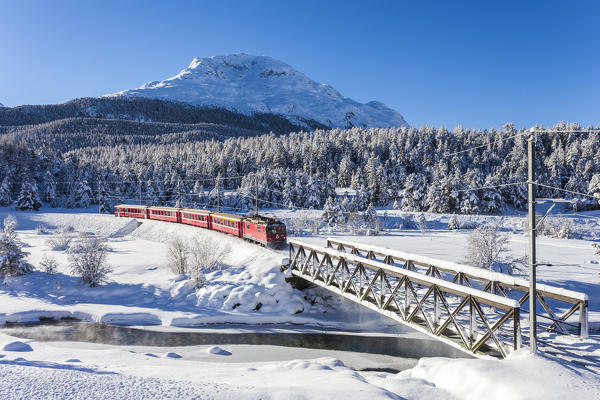 Bernina Express train in the snowy landscape, Pontresina, Engadine, canton of Graubunden, Switzerland