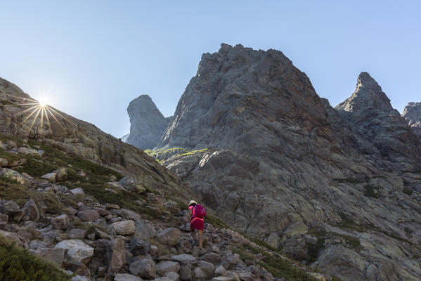 Hiker on rocks towards Monte Cinto, Haut-Asco, Corte, Corsica, France