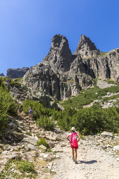 Hiker on footpath towards Lake Capitello (Lago di Capitellu), Val Restonica, Corte, Corsica, France 