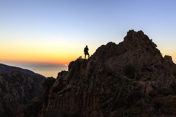 Hiker on Calanchi di Piana (Les calanques de Piana), gulf of Porto, Southern Corsica, France