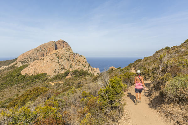 Hiker on footpath towards Capu Rossu, Cargese, Corsica, France