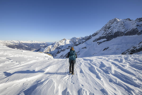 A woman observes panorama at Passo Presena, Trento, Val Presena, Trentino Alto Adige, Italy, Southern Europe