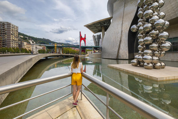 Woman looks at Guggenheim Museum, Bilbao, Basque country, Spain, Iberian Peninsula, Western Europe