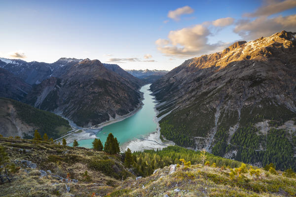 Elevated view from Crap del la Parè of Livigno lake and mountains that sourround it at sunset, Sondrio, Valtellina, Lombardy, Italy, Southern Europe